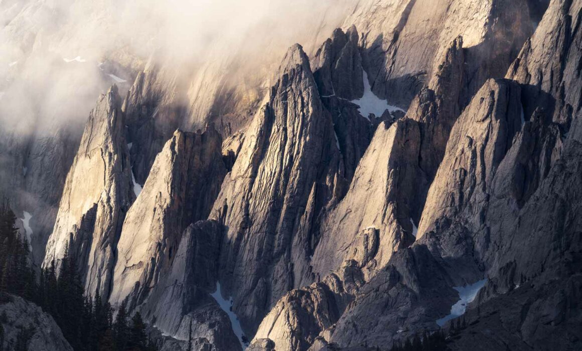 Golden sunset light outlines detailed rock features on the face of Abraham Mountain photographed by Nick Fitzhardinge