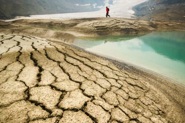 Glacial silt build up at the foot of the retreating Peyto Glacier is dried and cracked under a summer smoke haze photographed by Nick Fitzhardinge.