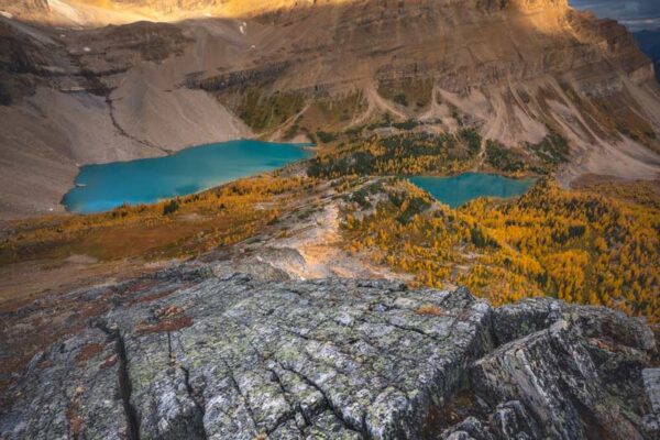Skoki Lakes in fall beneath the towering Wall of Jericho at sunrise photographed by Nick Fitzhardinge.